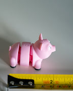 pig figure next to measuring tape for scale
