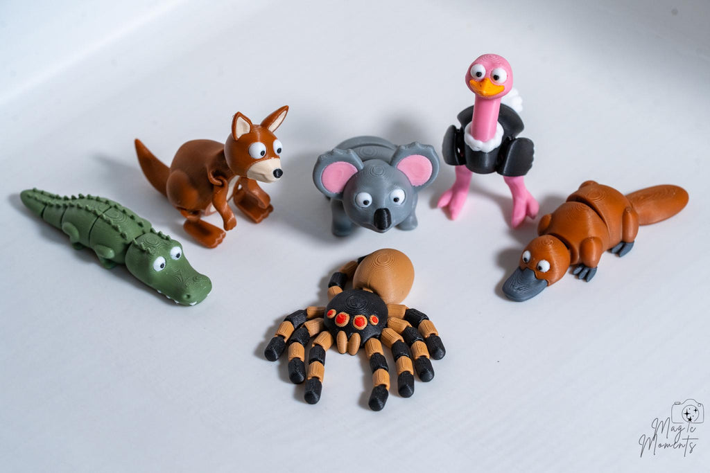 Set of animals figurines including a crocodile, kangaroo, koala, ostrich, spider and platypus.