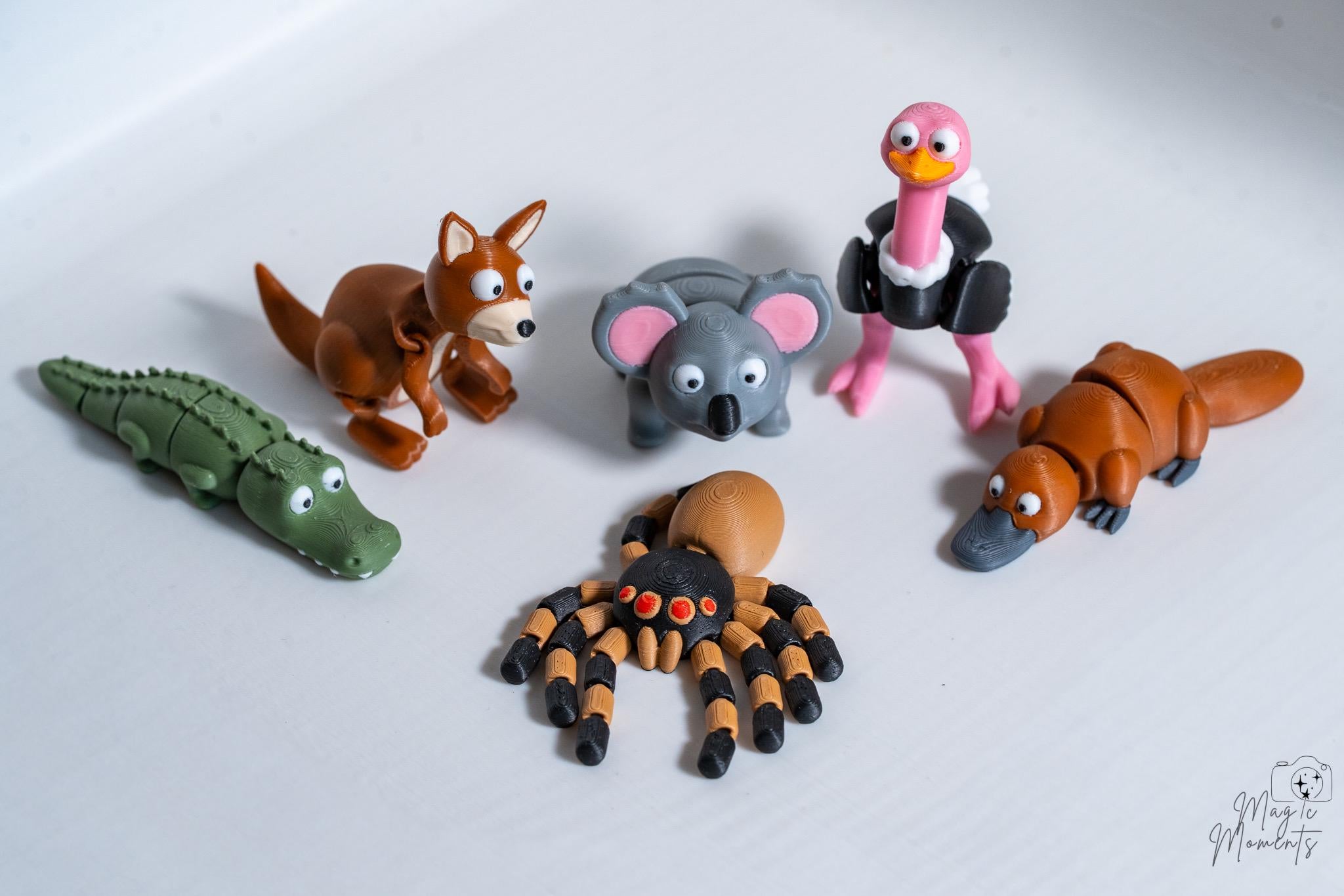 Set of animals figurines including a crocodile, kangaroo, koala, ostrich, spider and platypus.
