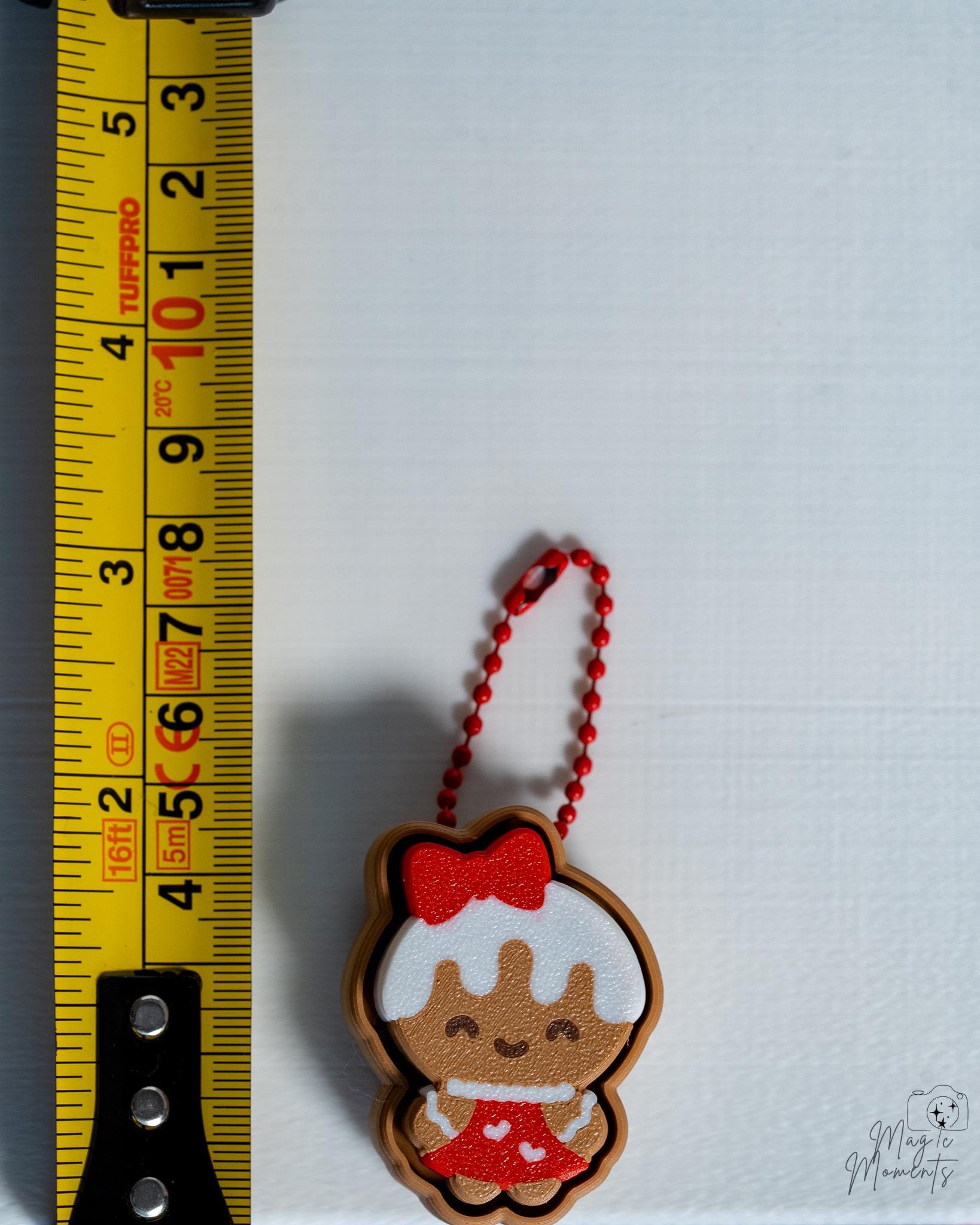 gingerbread girl clicker next to measuring tape for scale