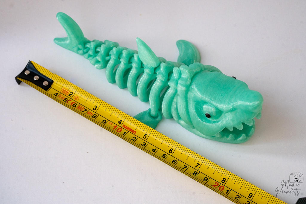 Skeletal shark figure next to measuring tape for scale