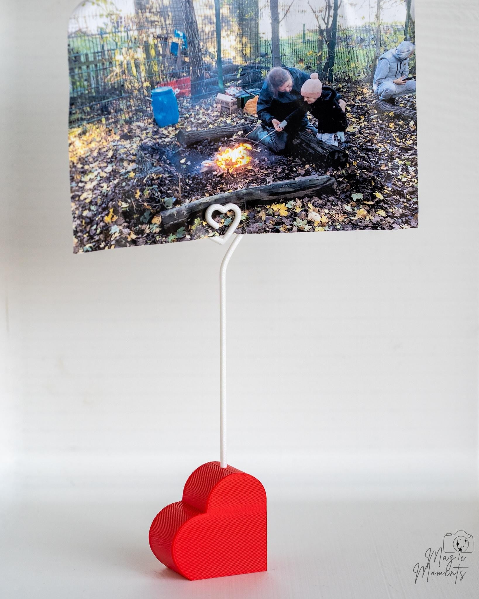 Heart photo stand displaying printed photographs