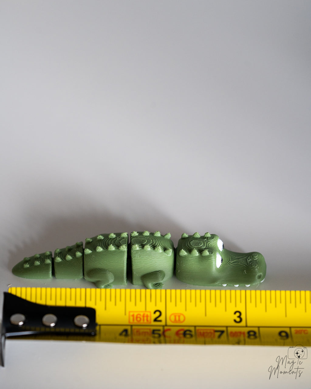 Crocodile figure next to measuring tape for scale
