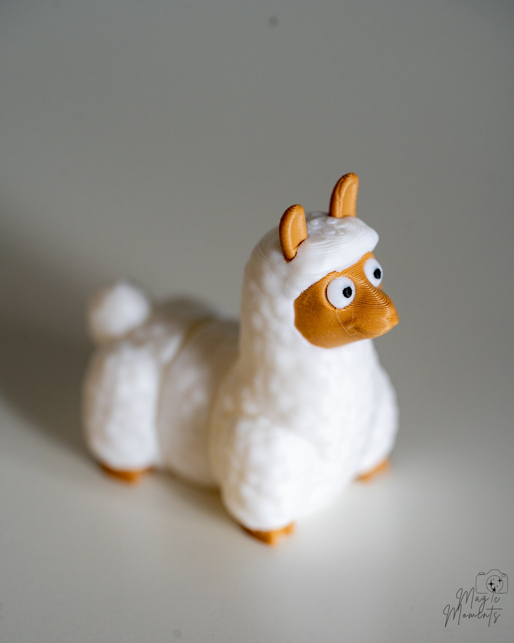 White llama figure viewed from side