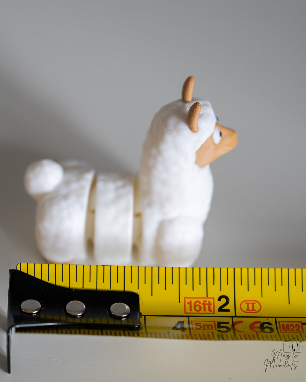 llama figure next to measuring tape for scale