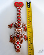 Valentine dragon figure next to measuring tape for scale