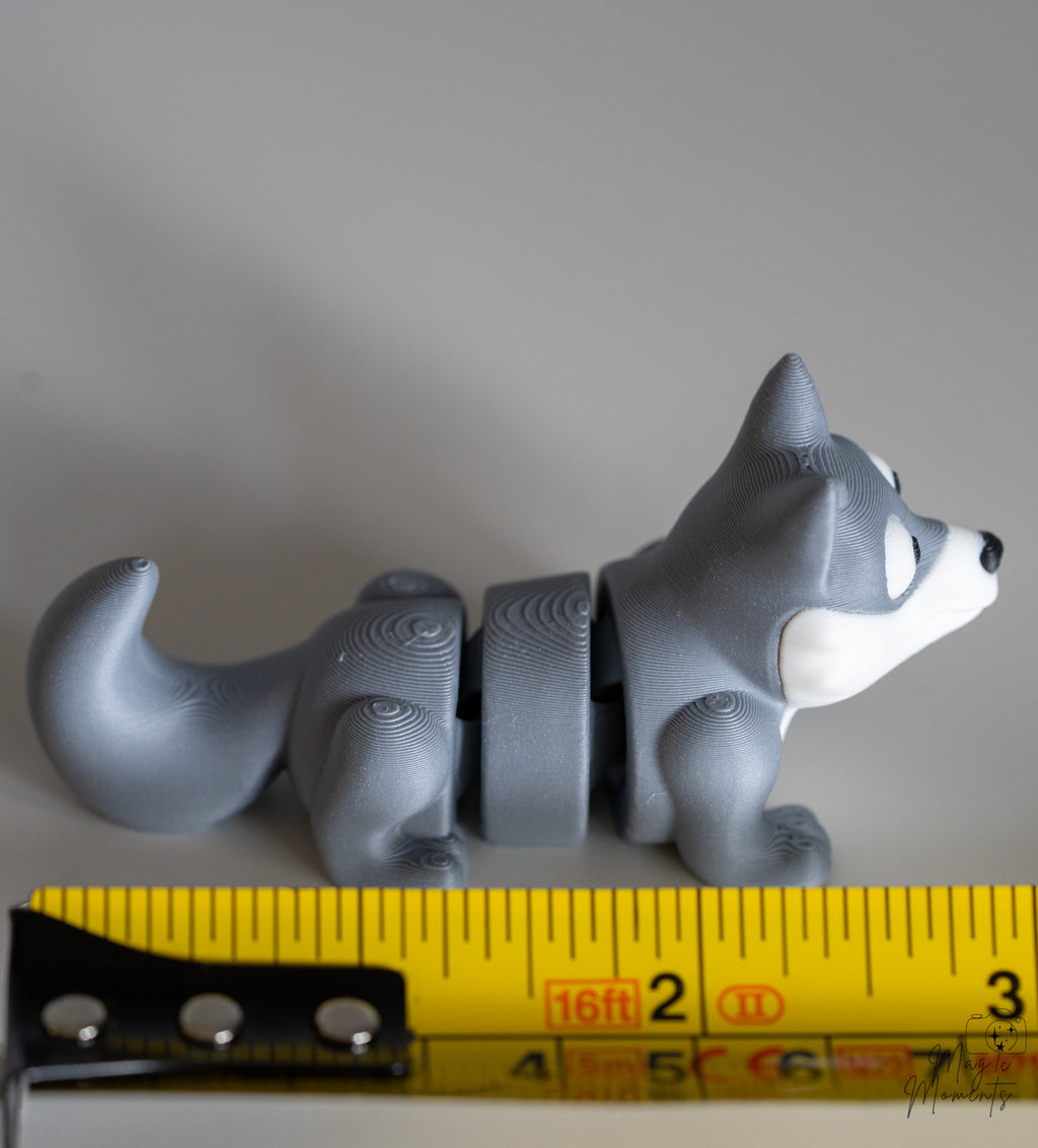 wolf figurine next to measuring tape for scale