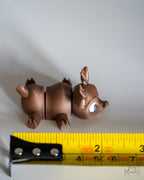 reindeer figurine next to measuring tape for scale