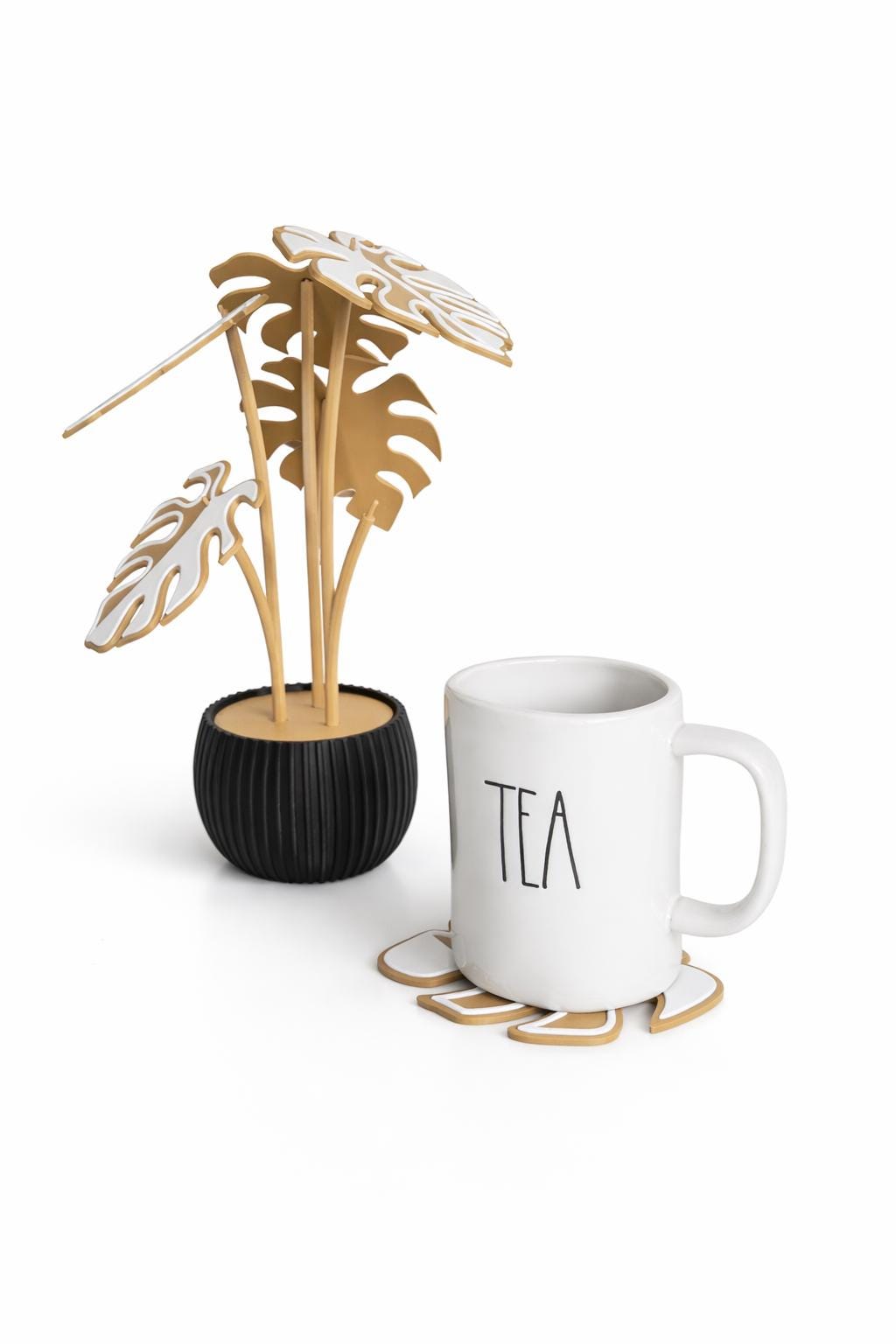 monstera plant coaster decor next to mug