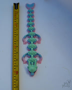 Crystal dragon next to measuring tape for scale