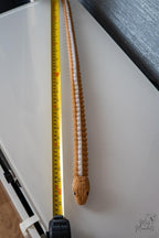 Snake figure next to measuring tape for scale