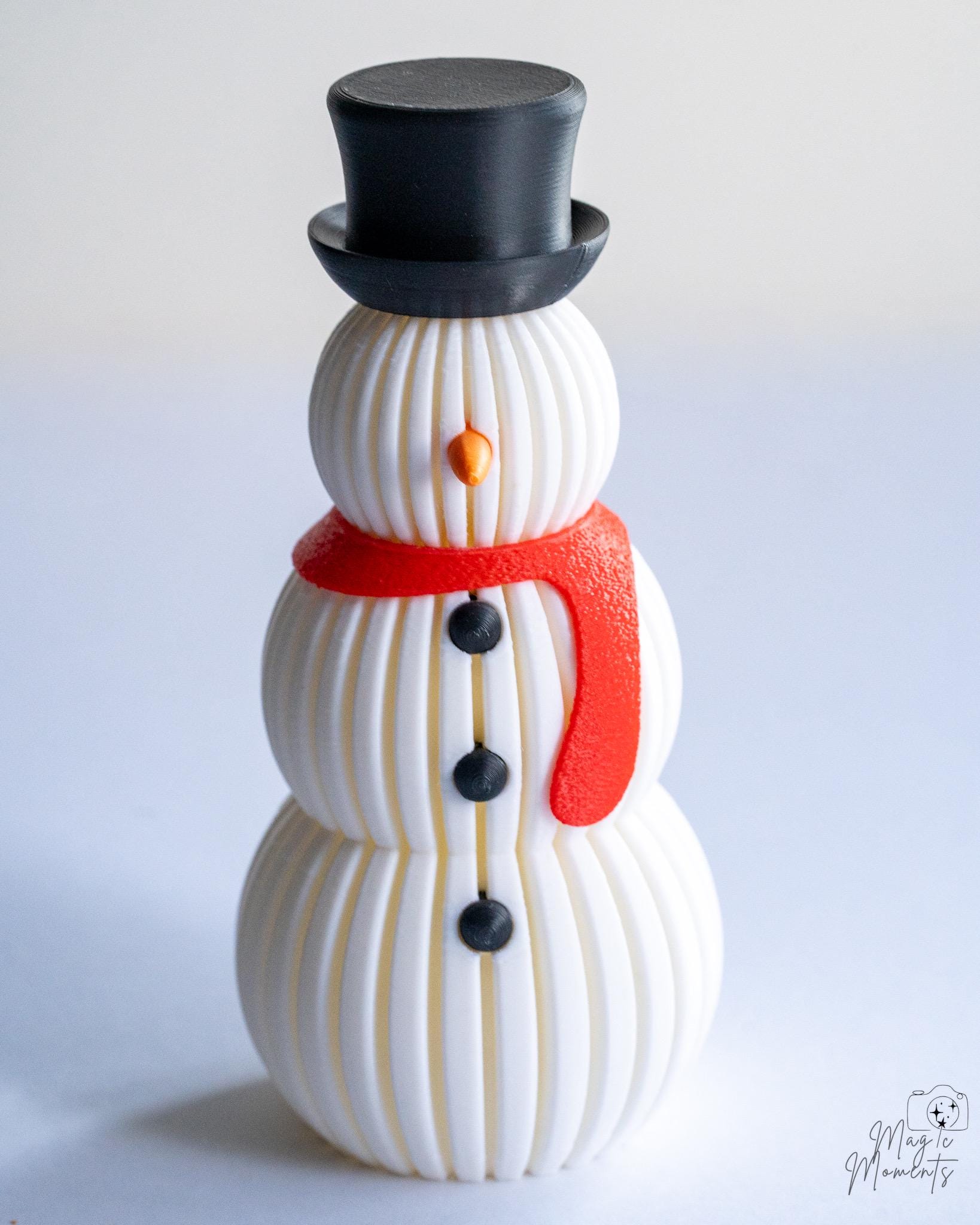 Snowman figure with black hat and red scarf detail