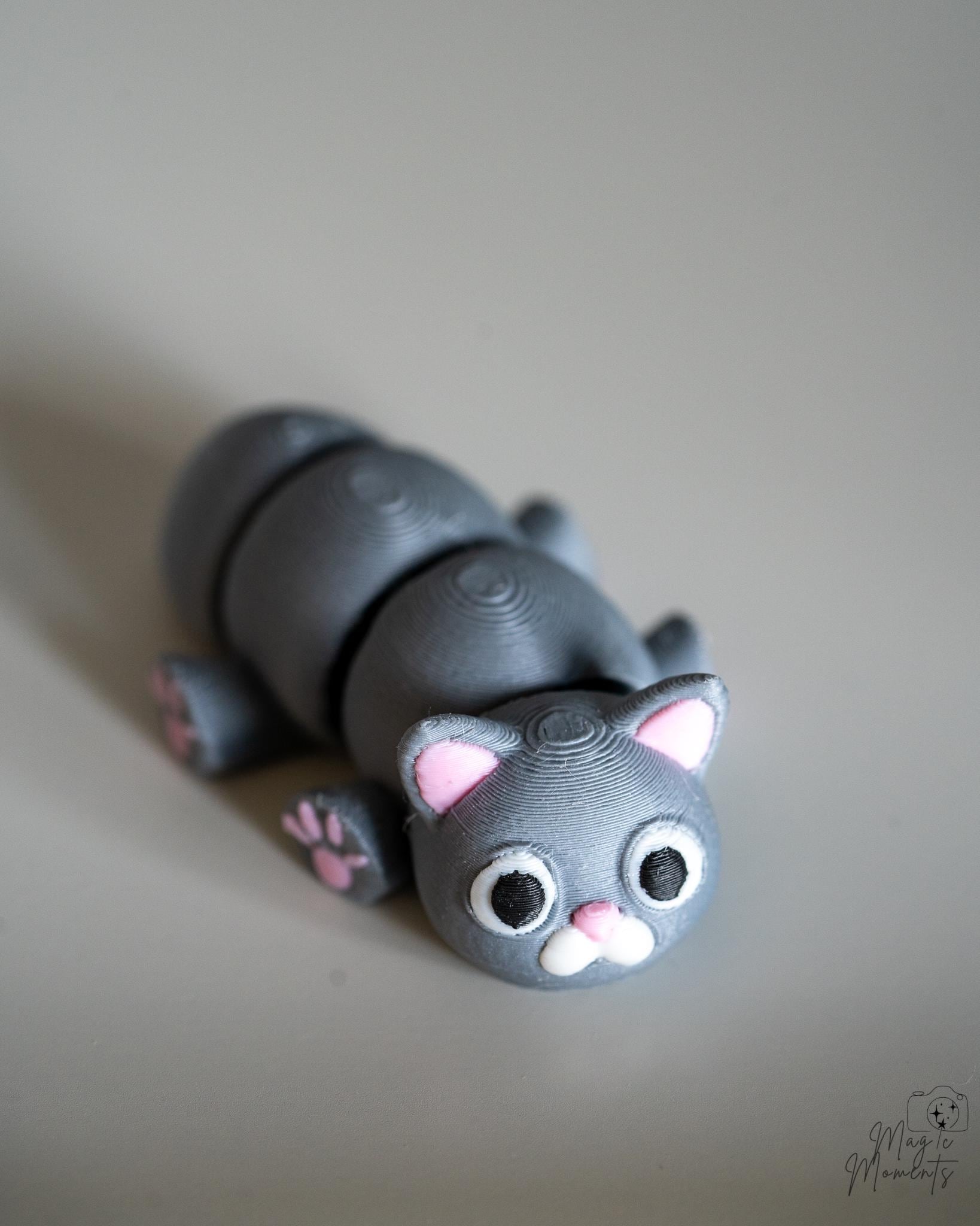 Gray cat figurine with pink accents 