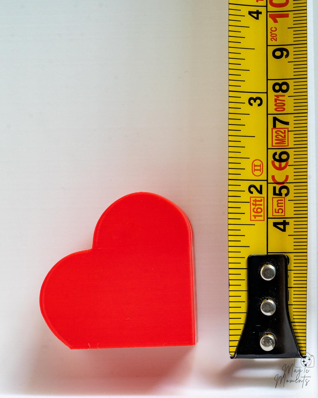 Heart photo holder next to measuring tape for scale