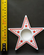 star candle holder next to measuring tape