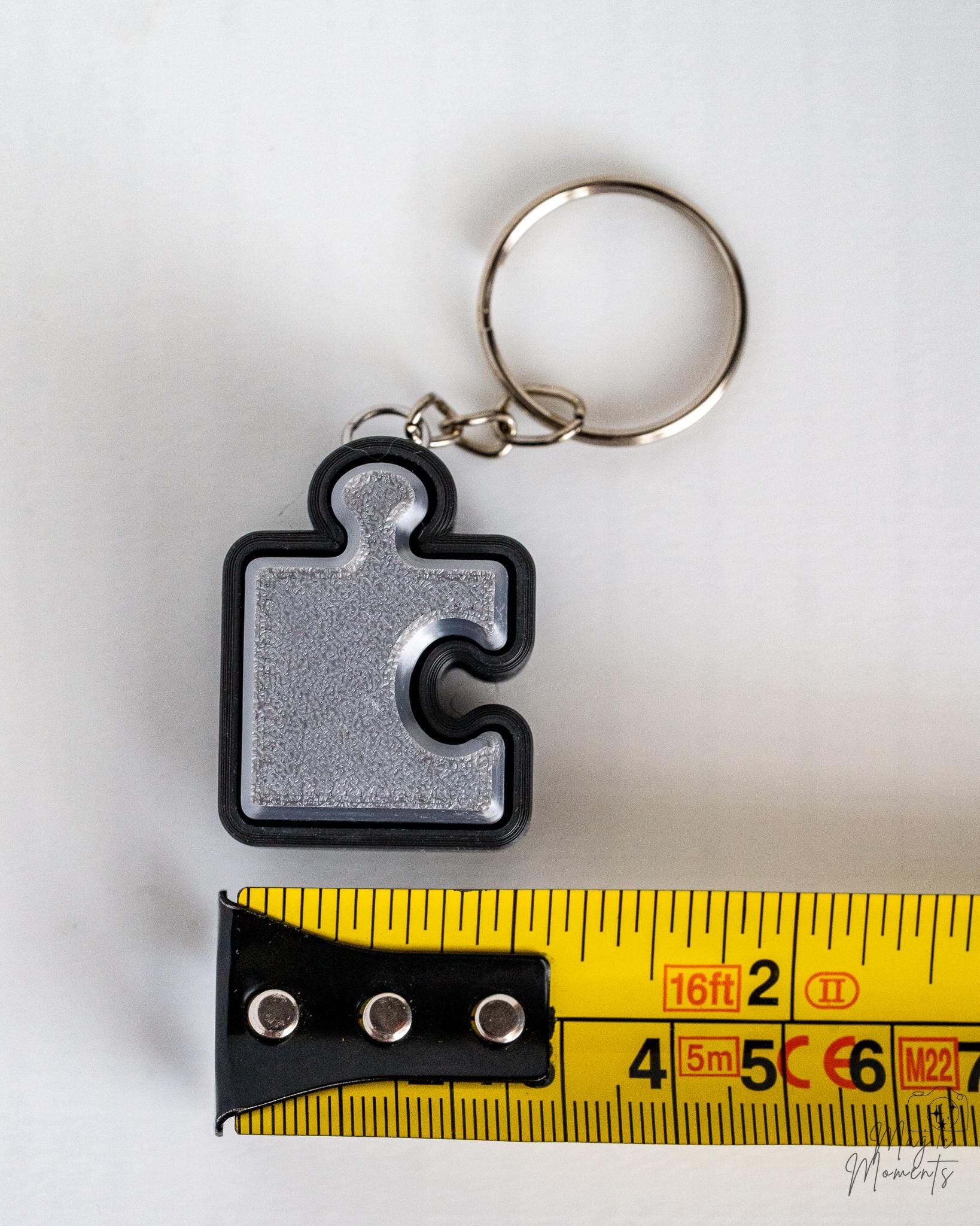 silver puzzle piece clicker keychain