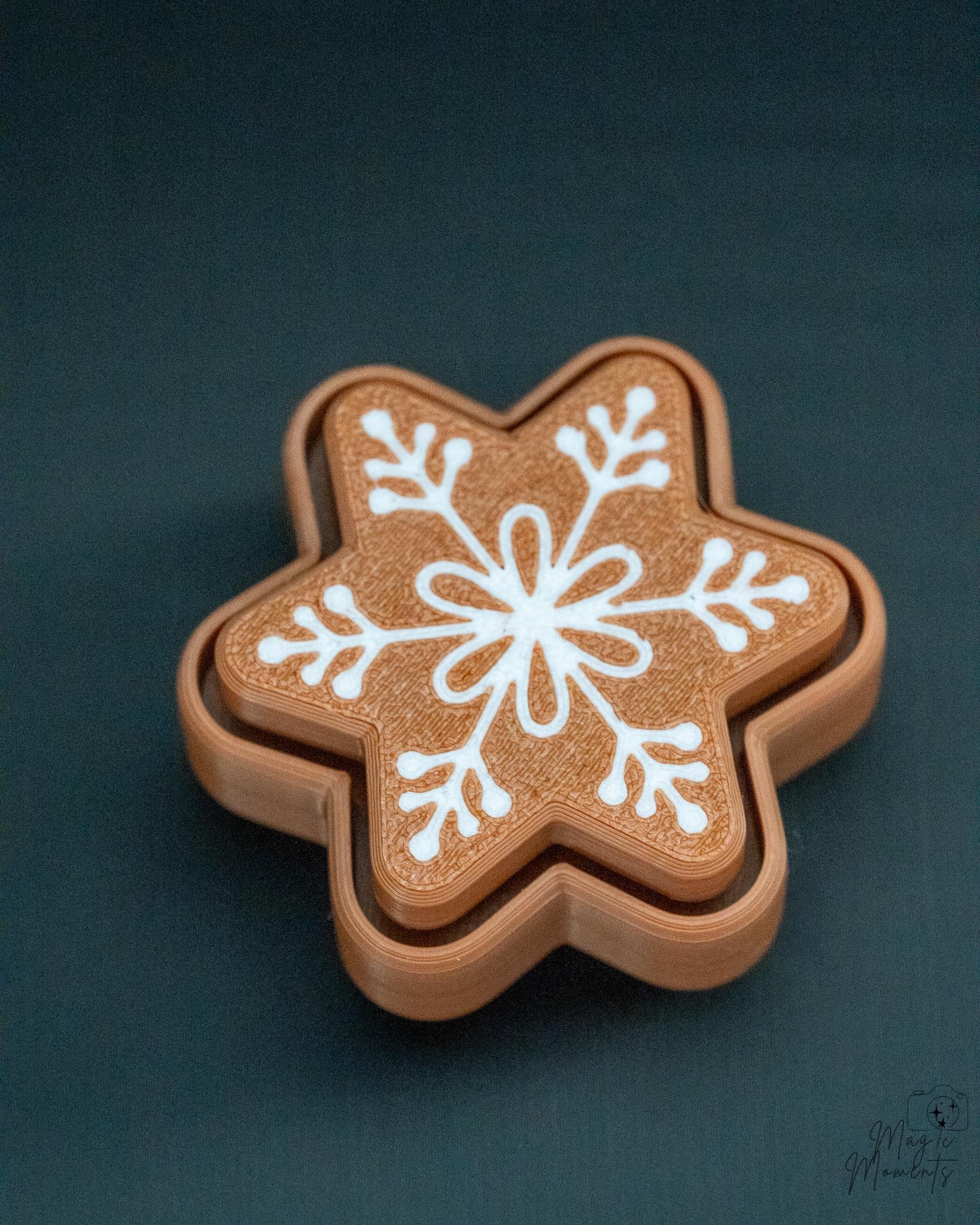 Snowflake gingerbread clicker with detailed white icing pattern