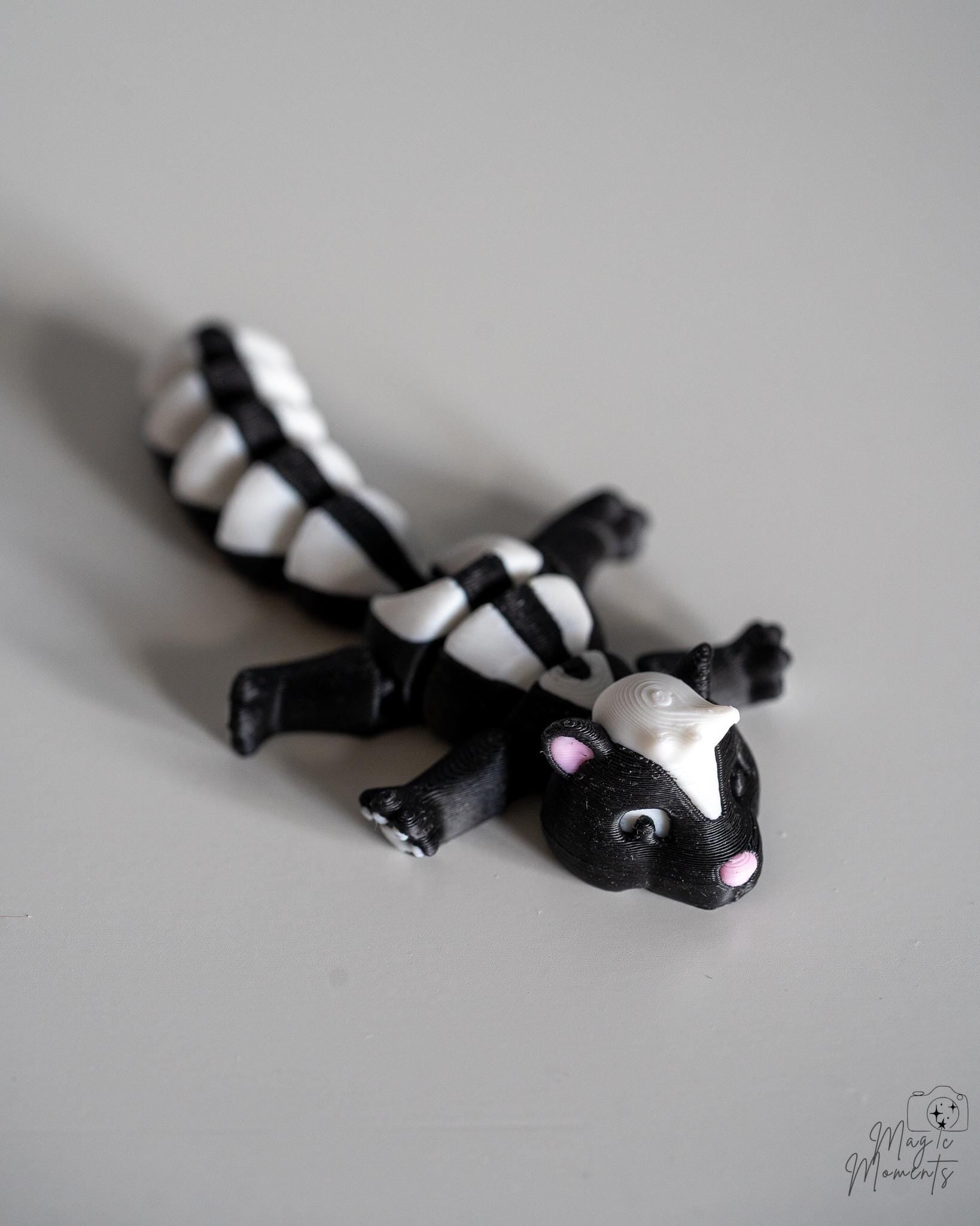 Articulated skunk figure with striped tail and flexible body