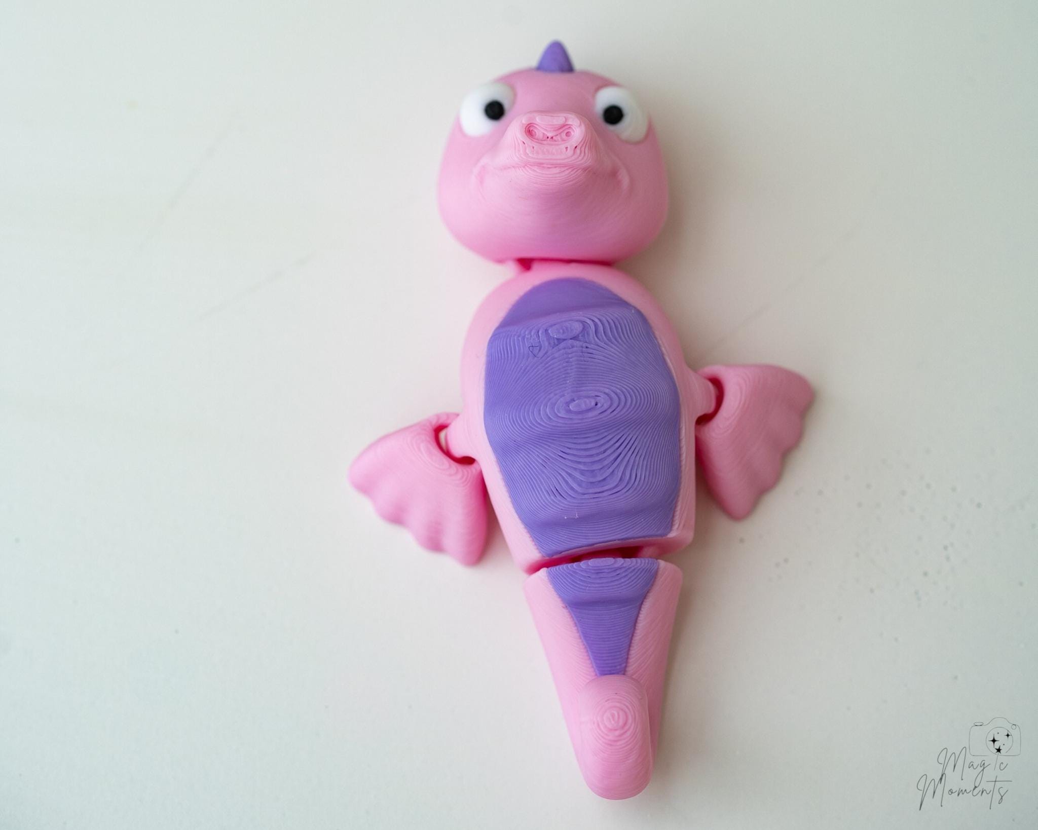 Pink articulated seahorse figure with flexible body design