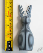 grey reindeer next to measuring tape for scale