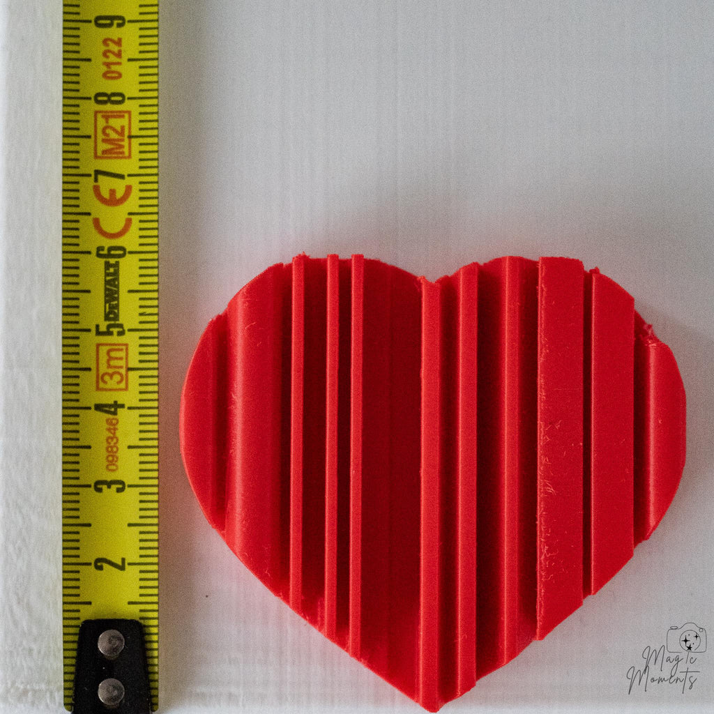 Heart decoration next to measuring tape for scale