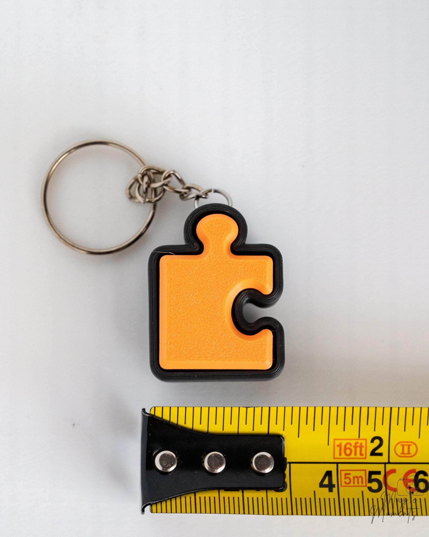 orange puzzle piece clicker keychain