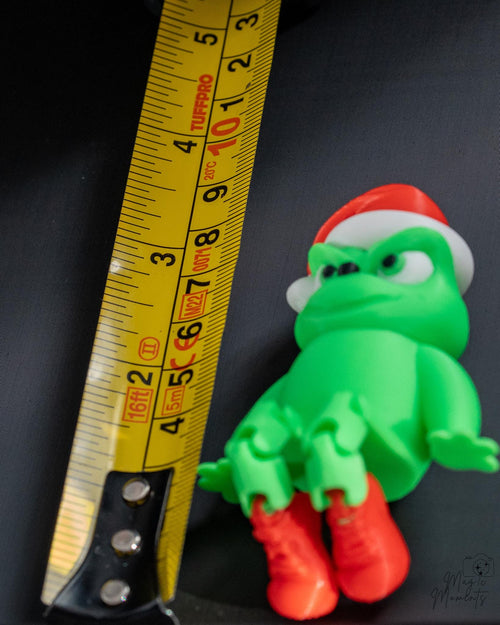 Green shelf sitter next to measuring tape for scale