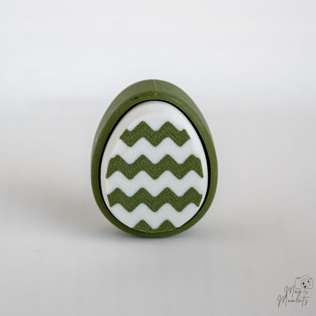 Easter egg clicker with zigzag pattern and green white design