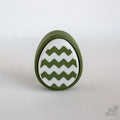 Easter egg clicker with zigzag pattern and green white design