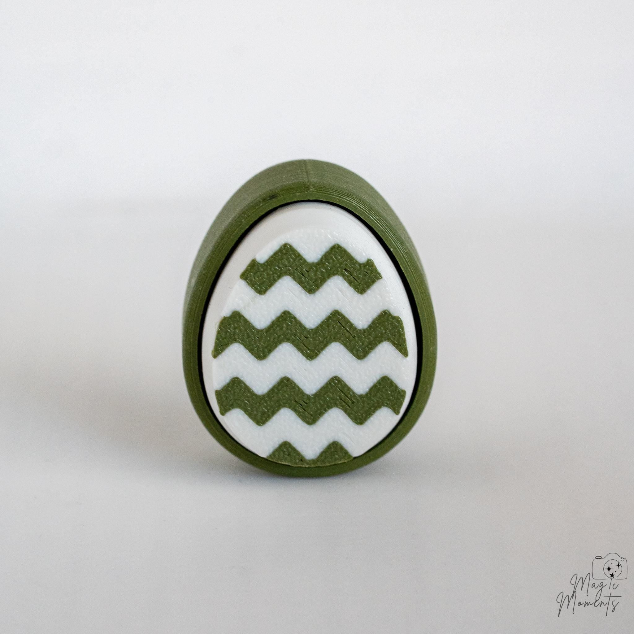 Easter egg clicker with zigzag pattern and green white design