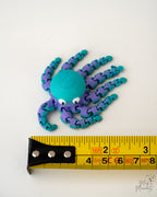 octopus figurine with a measuring tape for scale 