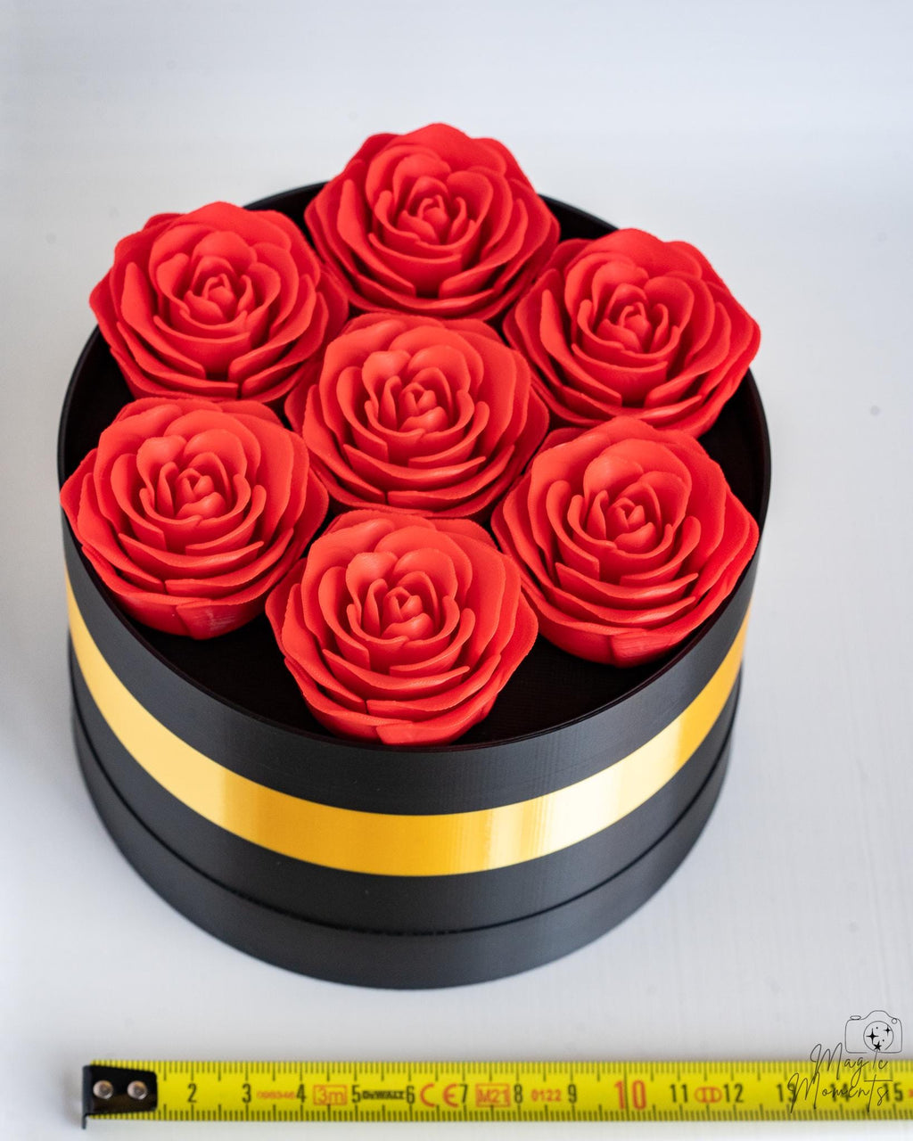 Black and gold rose box viewed from above next to measuring tape for scale