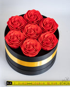 Black and gold rose box viewed from above next to measuring tape for scale