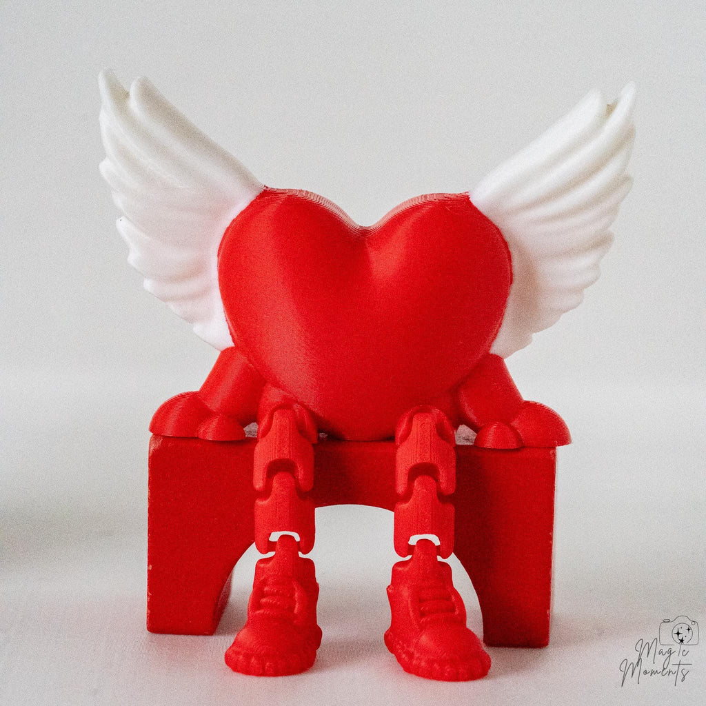 Winged heart shelf sitter decoration with dangling legs and Valentine design