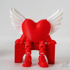 Winged heart shelf sitter decoration with dangling legs and Valentine design