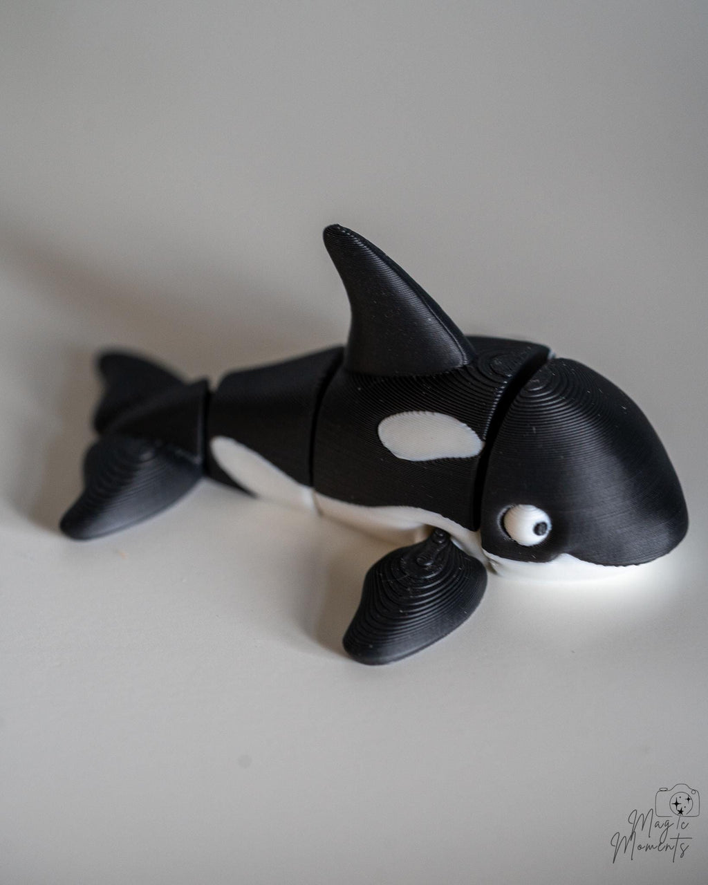 Articulated orca figure with black and white ocean themed design