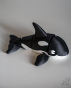 Articulated orca figure with black and white ocean themed design