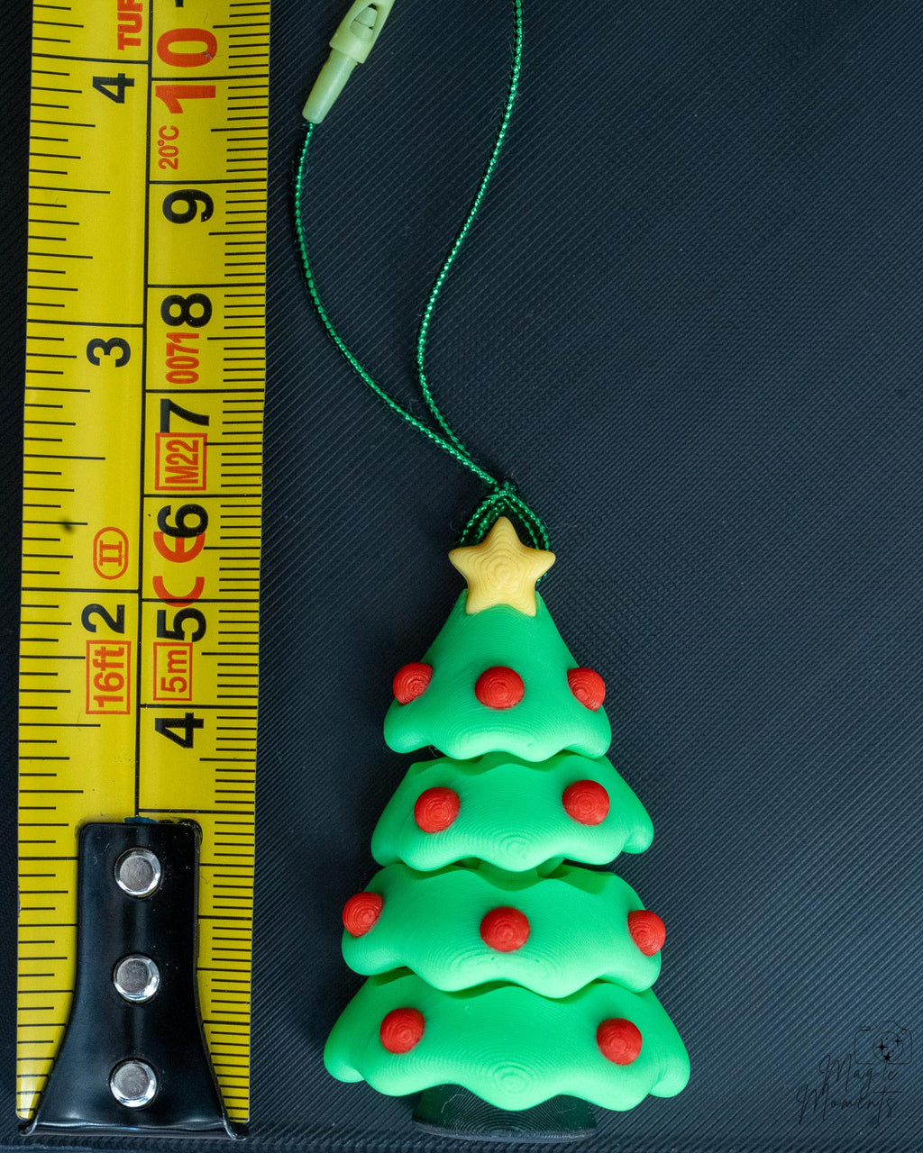 Christmas tree ornament next to measuring tape for scale