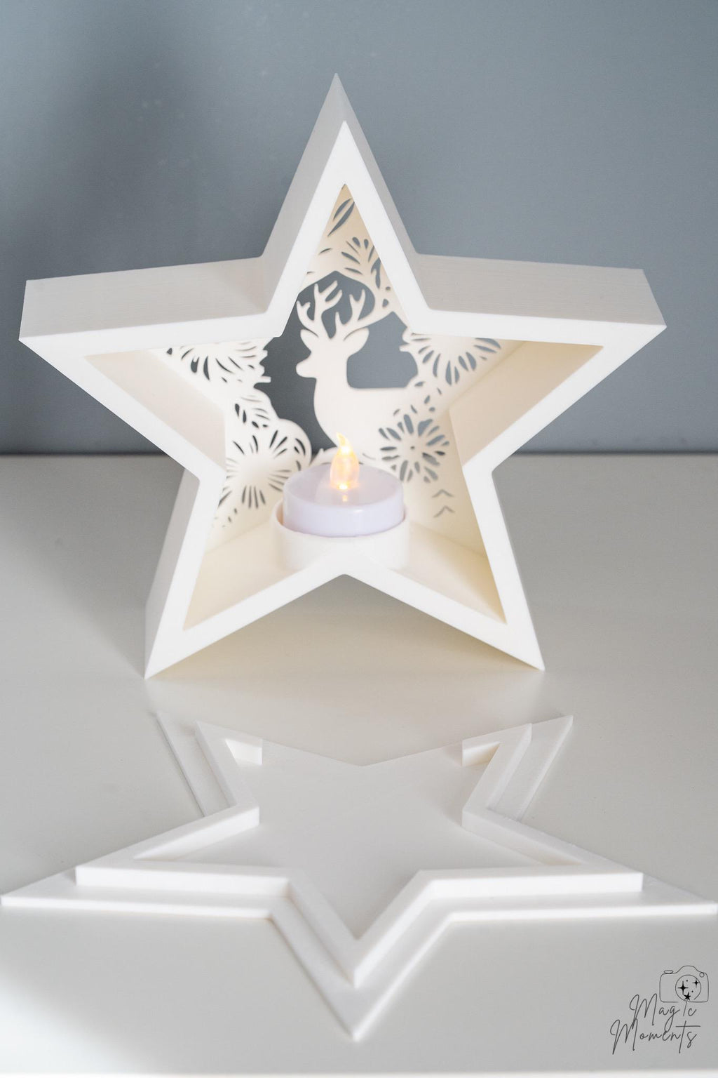 White star-shaped candle holder with cut-out design 