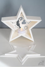 White star-shaped candle holder with cut-out design 