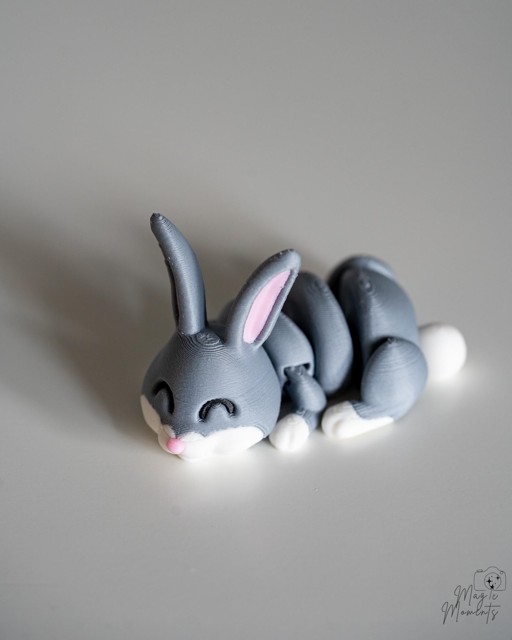 Gray rabbit/bunny figurine with white feet on a light gray background