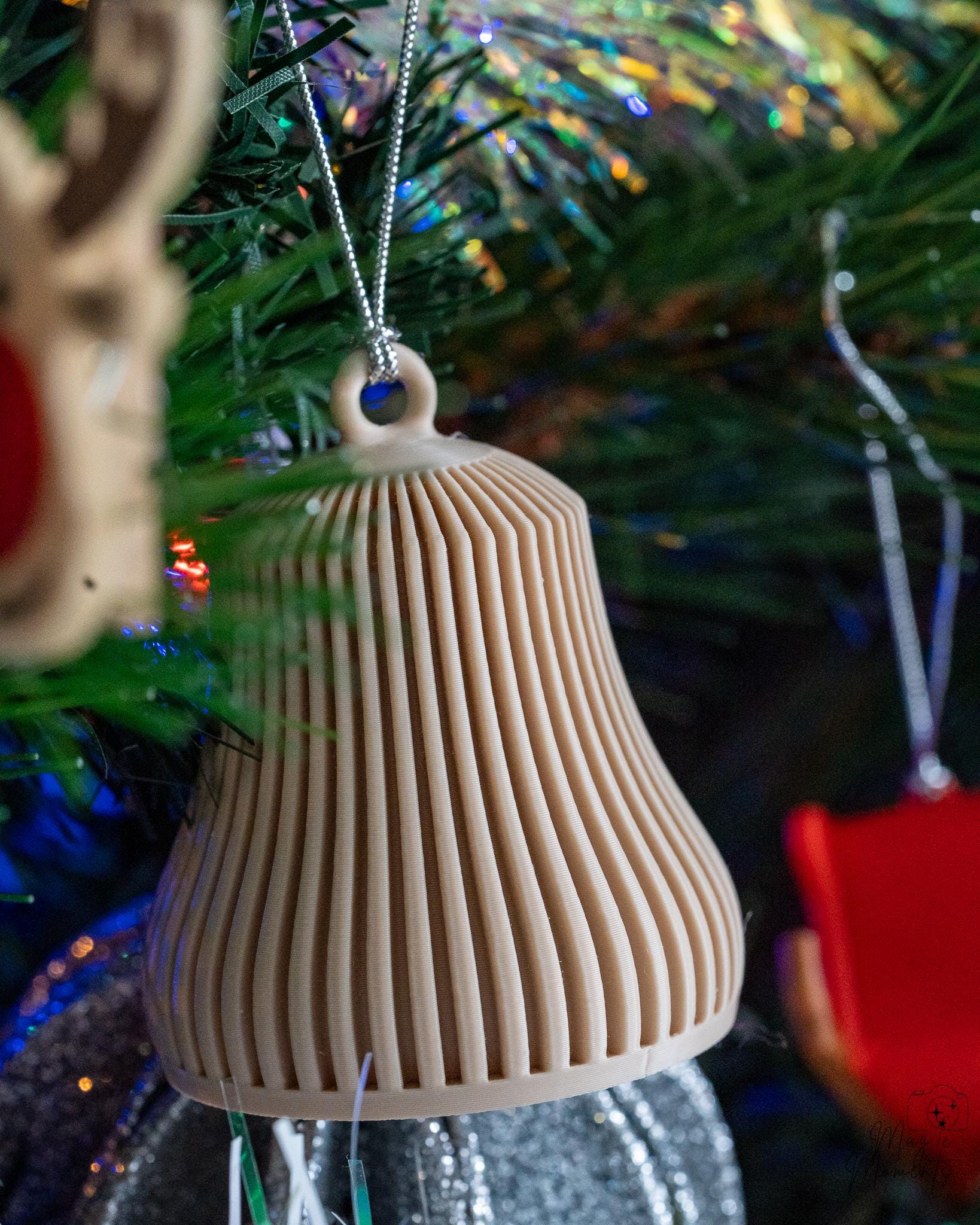 beige ribbed christmas bell ornament hanging on christmas tree