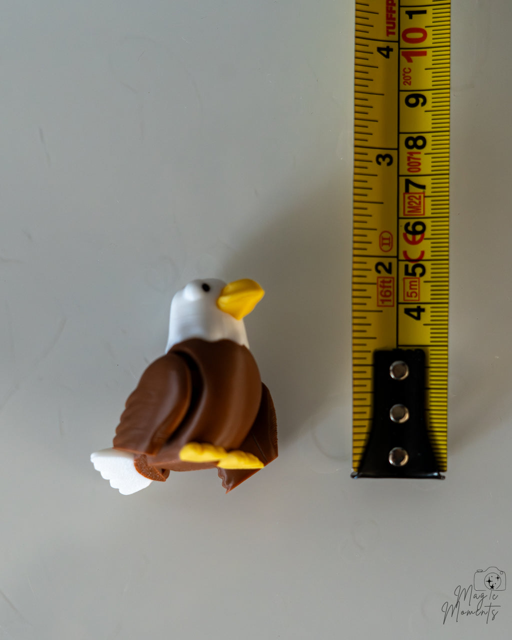 eagle figurine next to measuring tape for scale