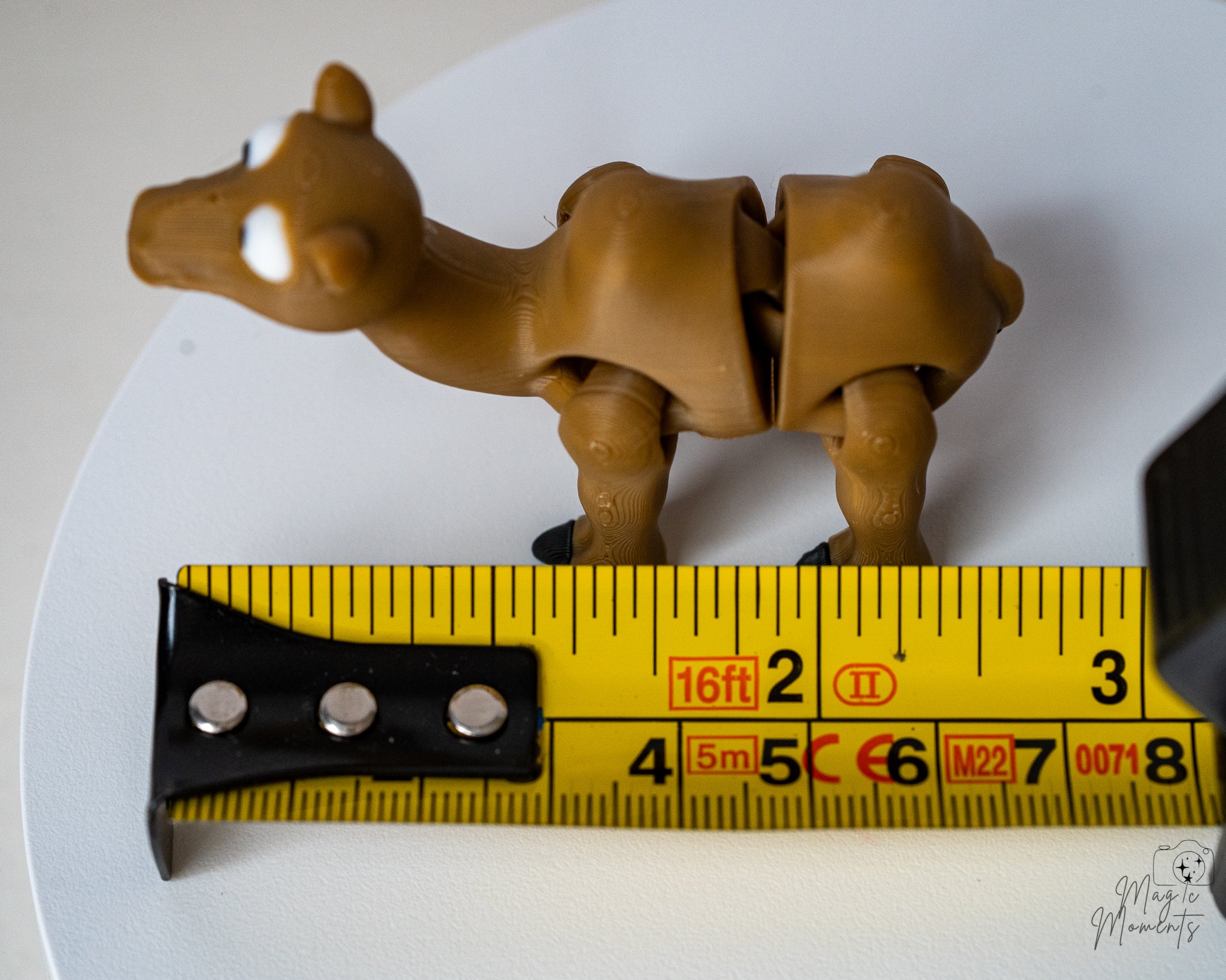 camel figurine next to measuring tape for scale