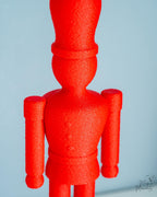 Close-up of red nutcracker decoration with fuzzy details
