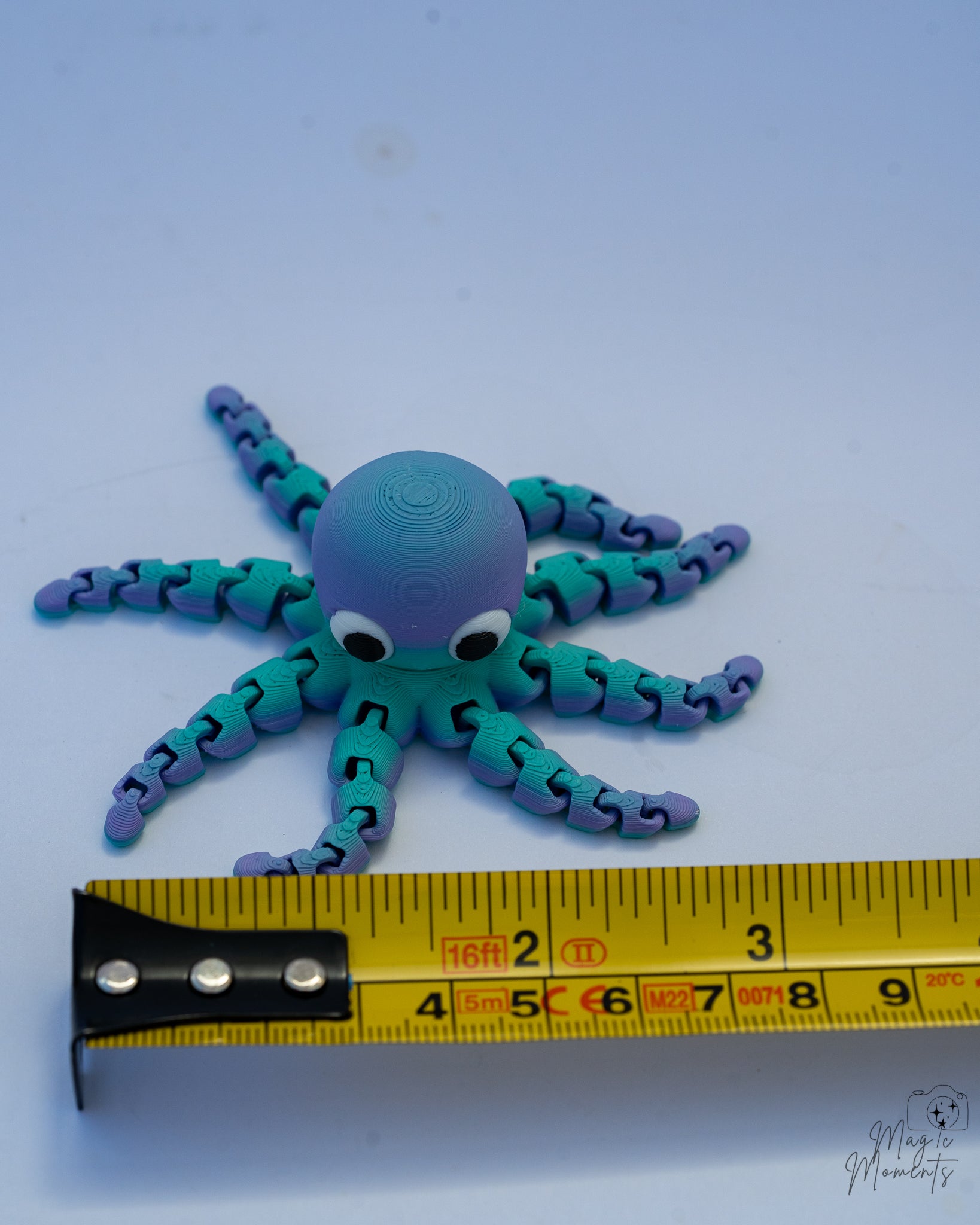 octopus figurine with a measuring tape for scale 