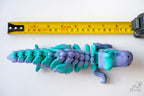 Dinosaur skeleton figure next to measuring tape for scale