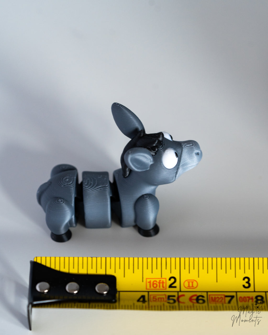 donkey figurine next to measuring tape for scale
