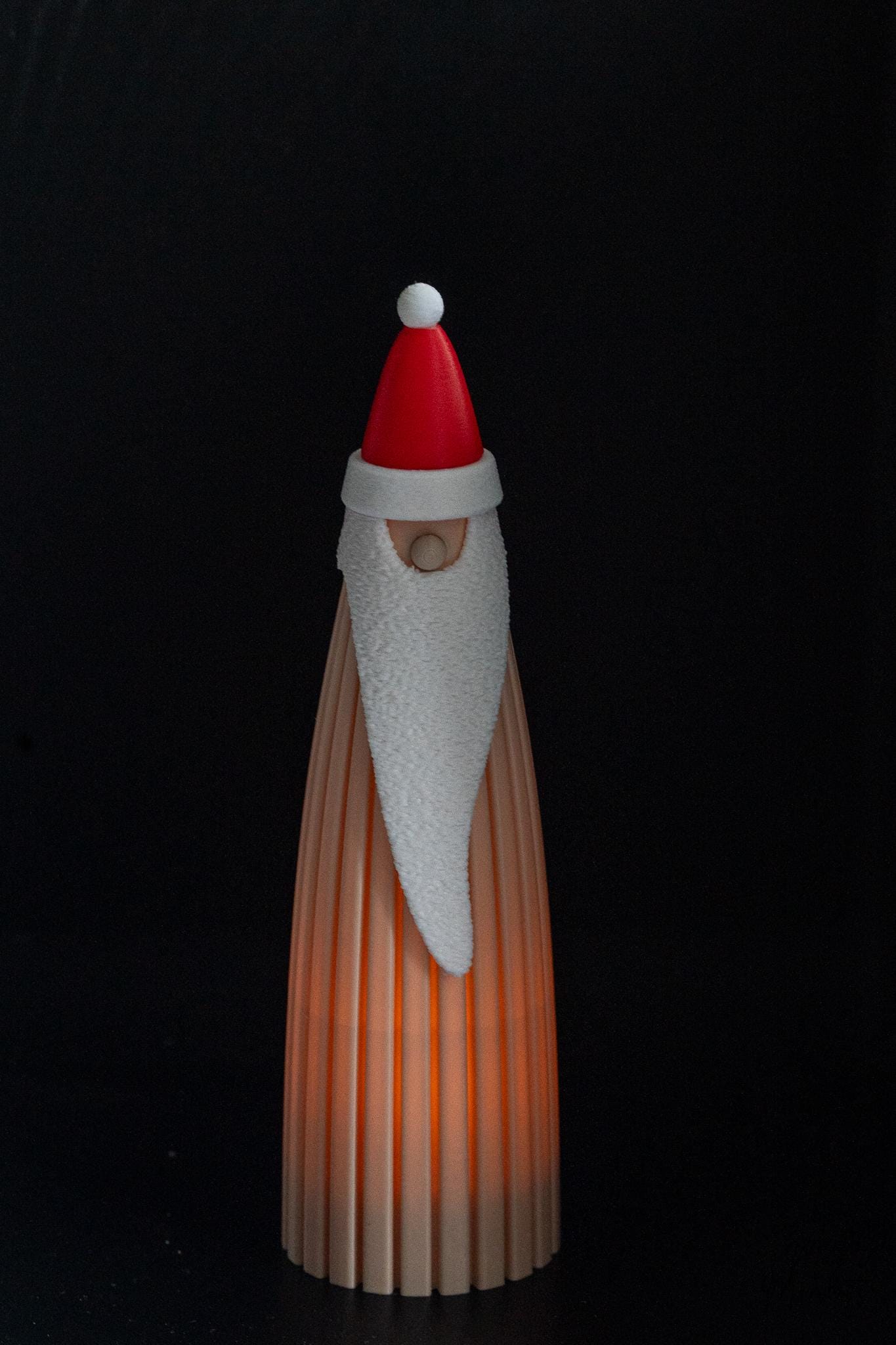 Santa decoration displayed on dark background with glowing effect