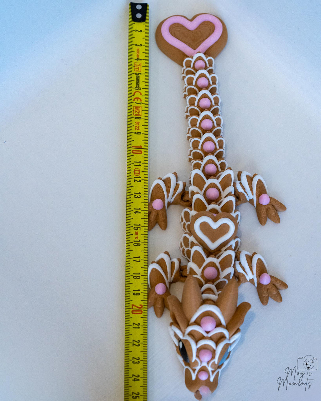 gingerbread dragon next to measuring tape for scale